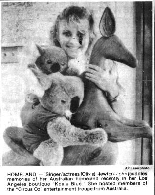 Olivia holding stuffed toy memories of her homeland at Koala Blue store - Desert Sun