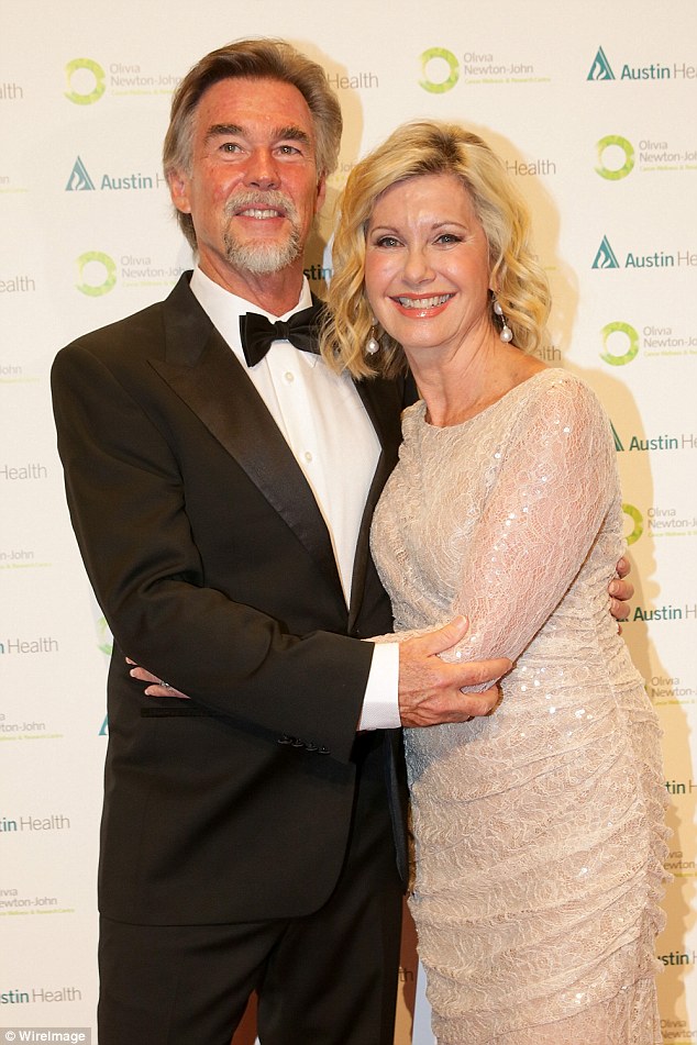 Olivia cuddles up to husband John Easterling at annual cancer charity gala - The Daily Mail