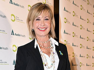 Olivia breaks down in tears as she is awarded a Companion of the Order of Australia - Daily Mail